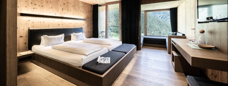 Viel Holz und Glas prägen die Zimmer, Suiten und Chalets.