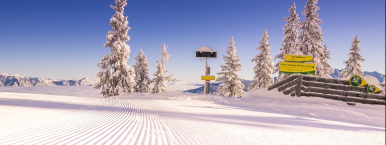 From Hochwurzen, a stunning panoramic view unfolds over the snow-covered mountain landscape.