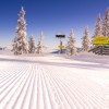 From Hochwurzen, a stunning panoramic view unfolds over the snow-covered mountain landscape.