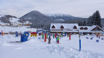 In the children fun park, magic carpets help with the first turns in the snow.